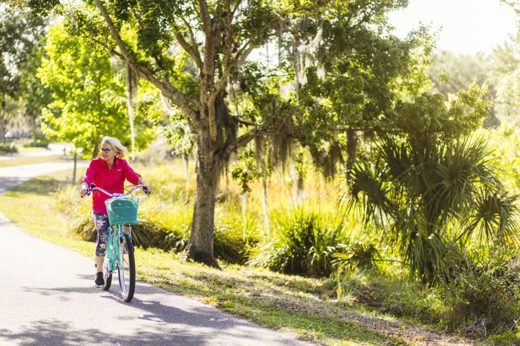 Senior woman riding her bike on bike trail