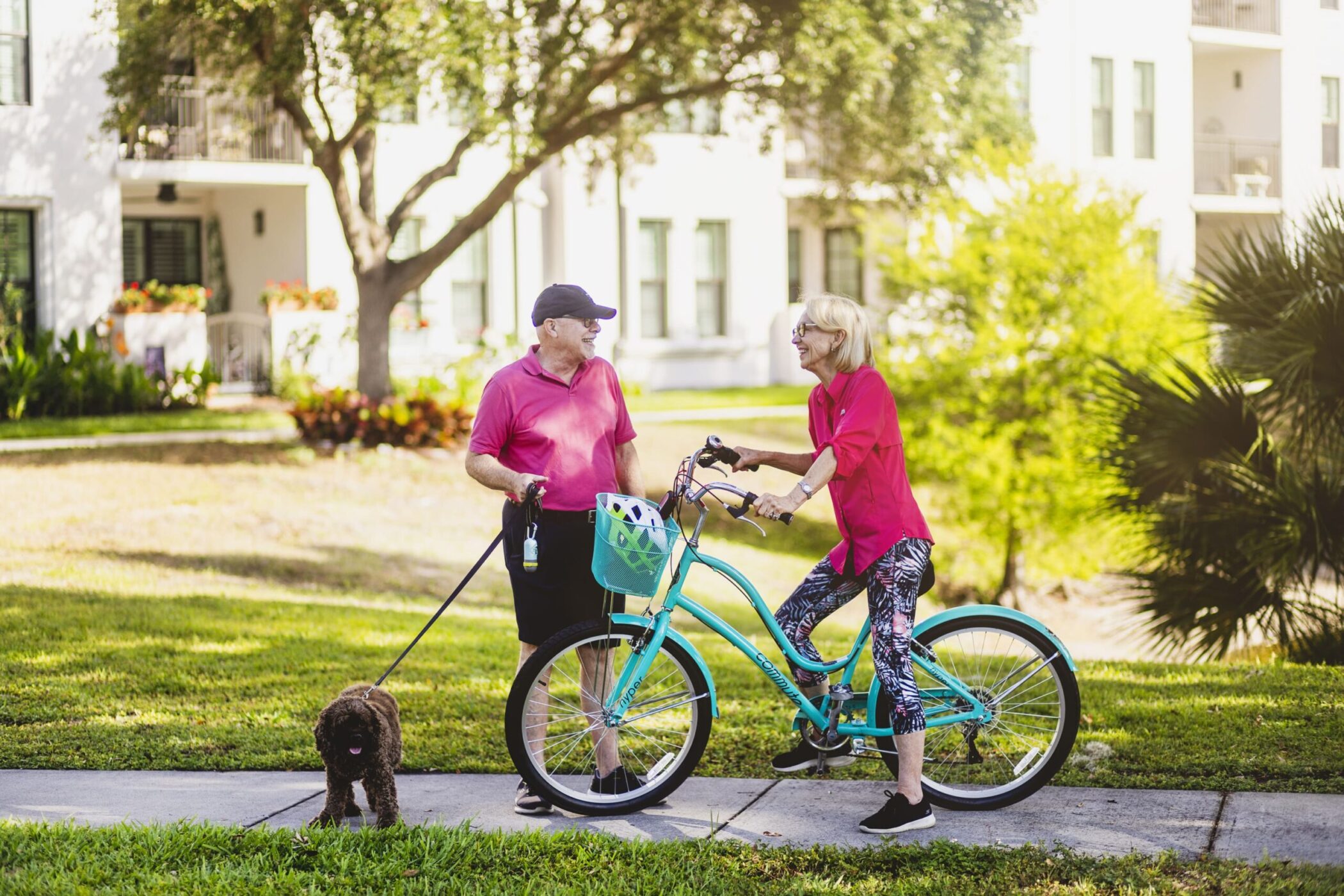 seniors outside walking dog and riding bike