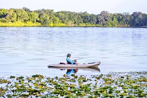 man fishes from kayak in Lake Berry in Winter Park, FL