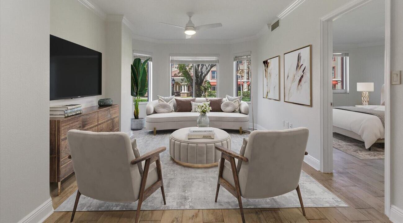 bright living room with large bay window and contemporary furniture opening onto a bedroom