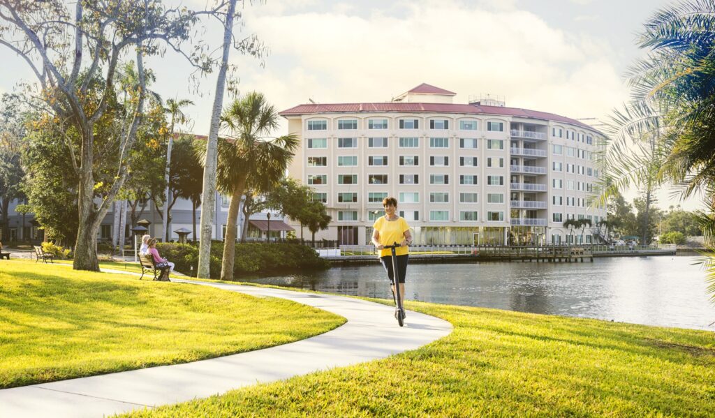 Senior riding scooter around the site