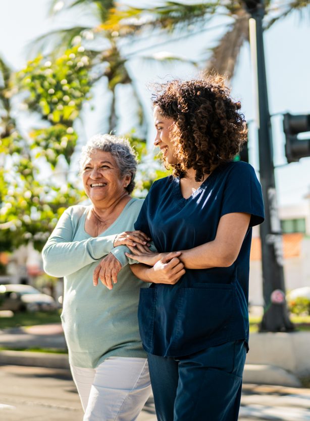 Assisted Senior Walking with Caregiver