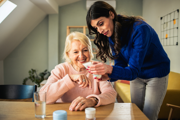 Senior and daughter reading lotion ingredients