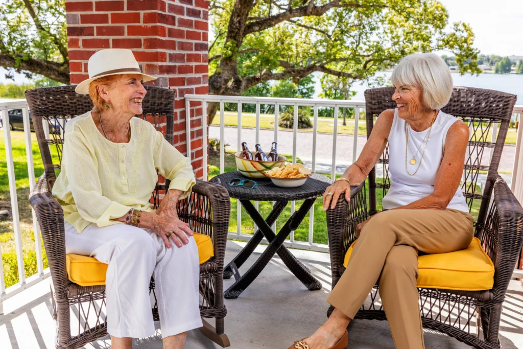 Seniors chatting on patio enjoying snacks