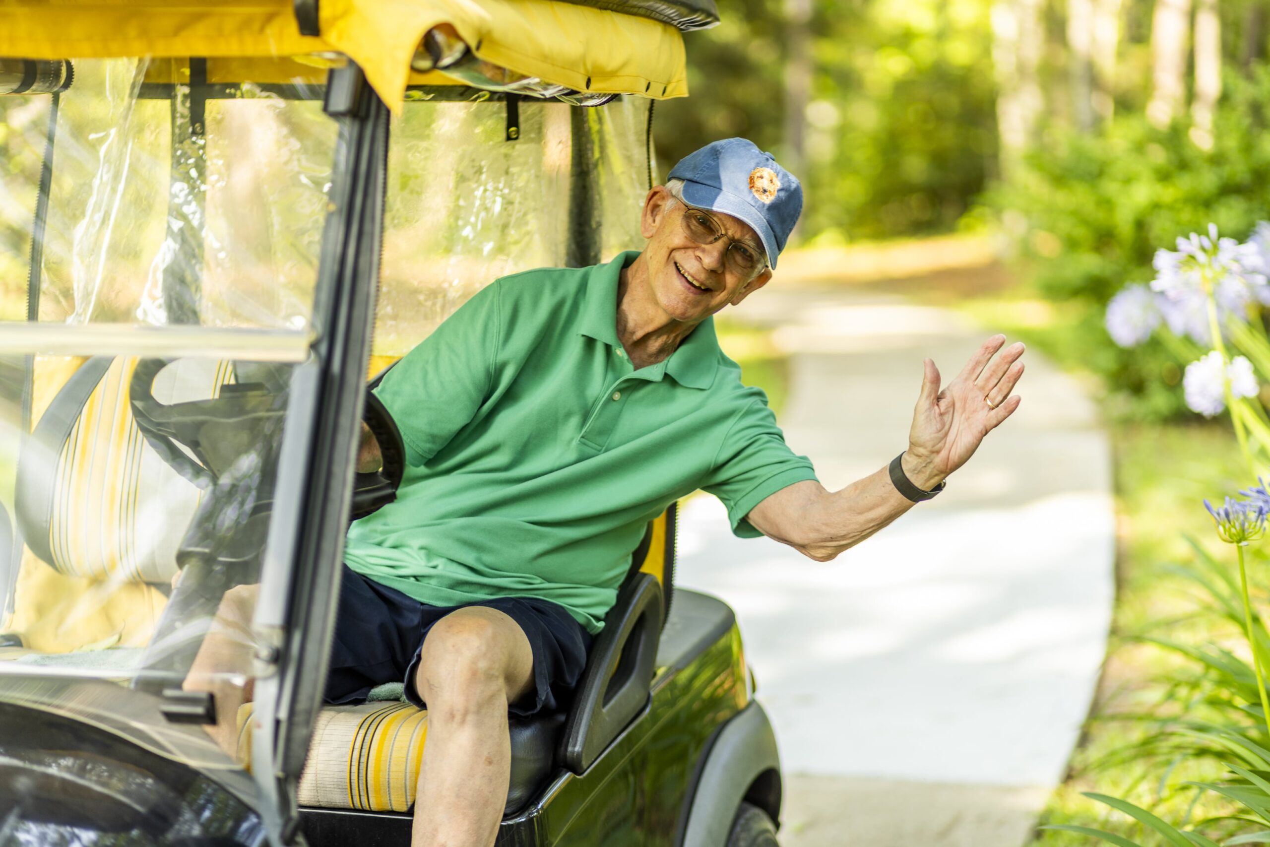 Senior ranger driving golf cart