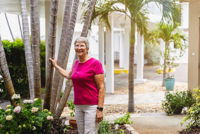 senior posing by tree