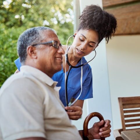 caregiver checking seniors heart rate