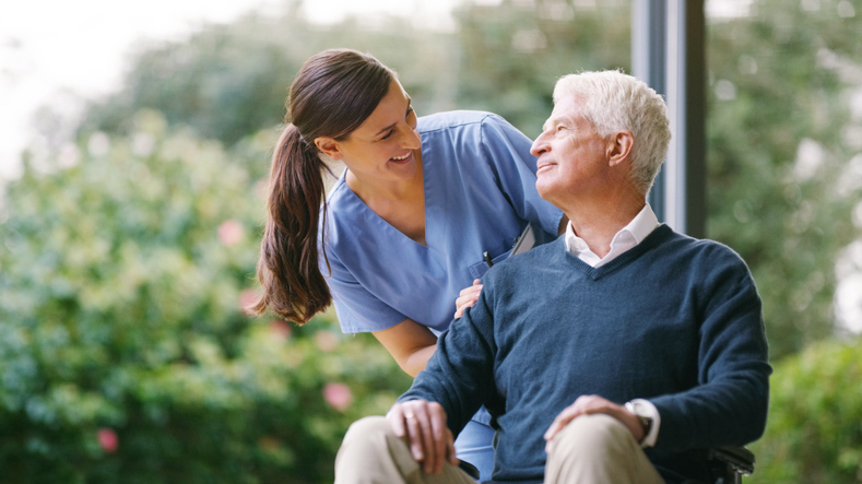 Caregiver comforting senior man