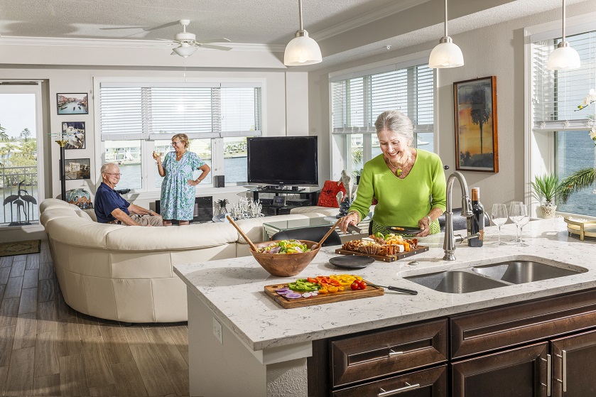 woman prepares a plate of food for guest and husband