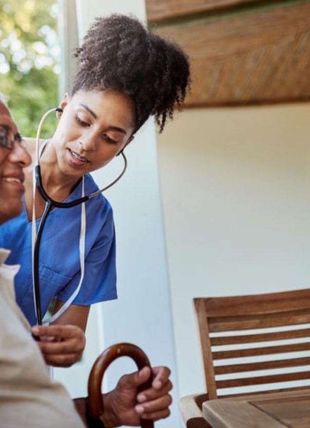Caregiver checking seniors man heart rate