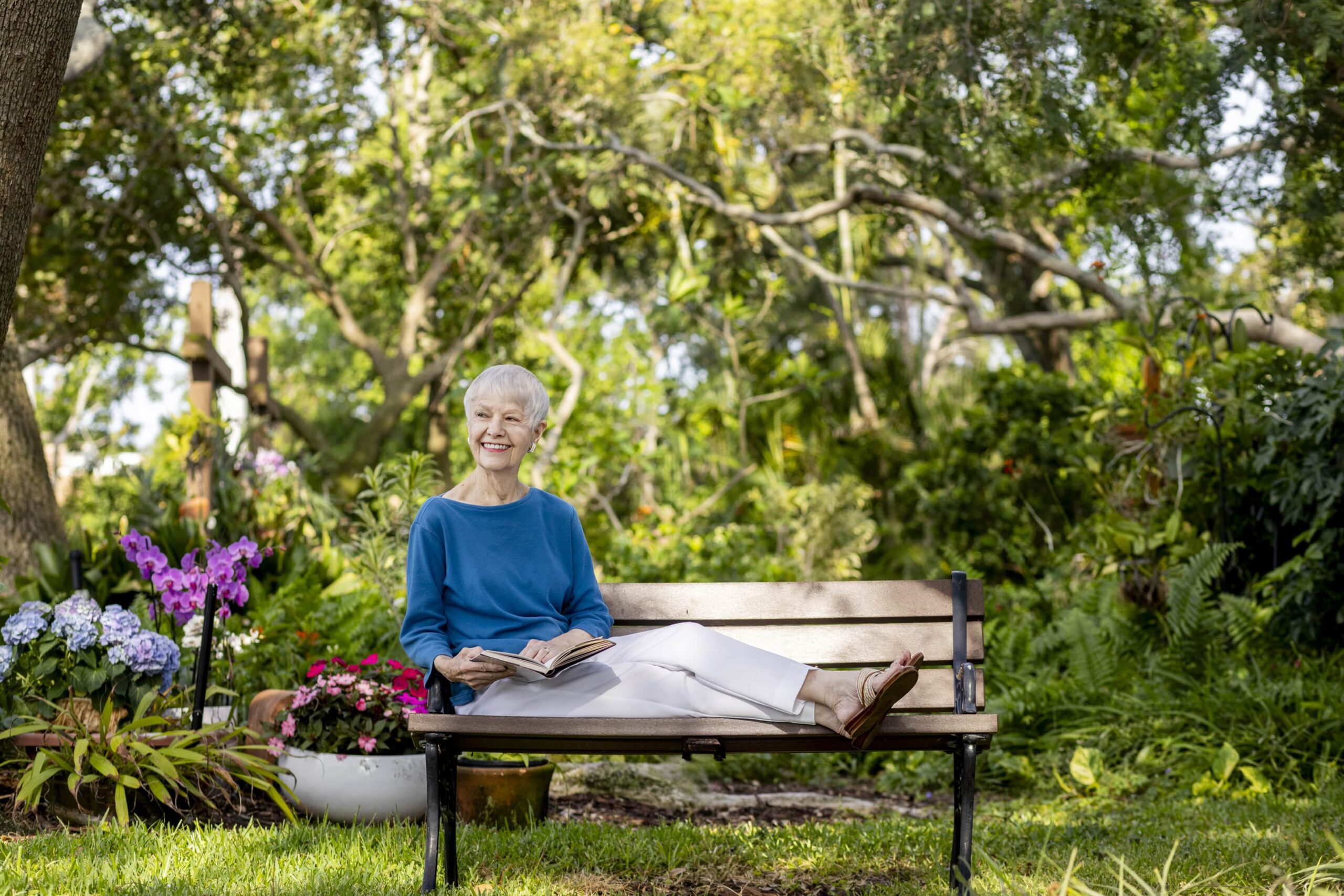 Senior Woman Sitting on a Bench Reading