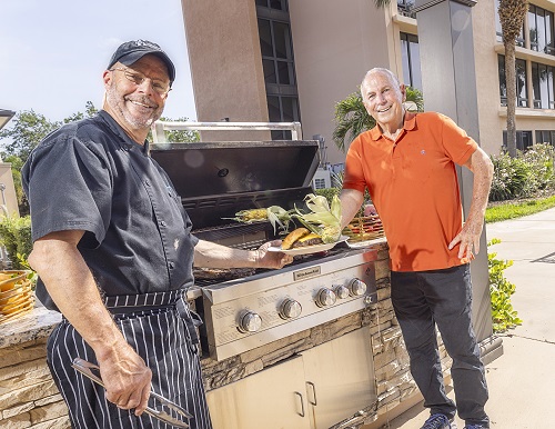 Chef serving senior man at the grill