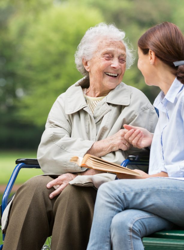 Senior woman with caregiver in the park