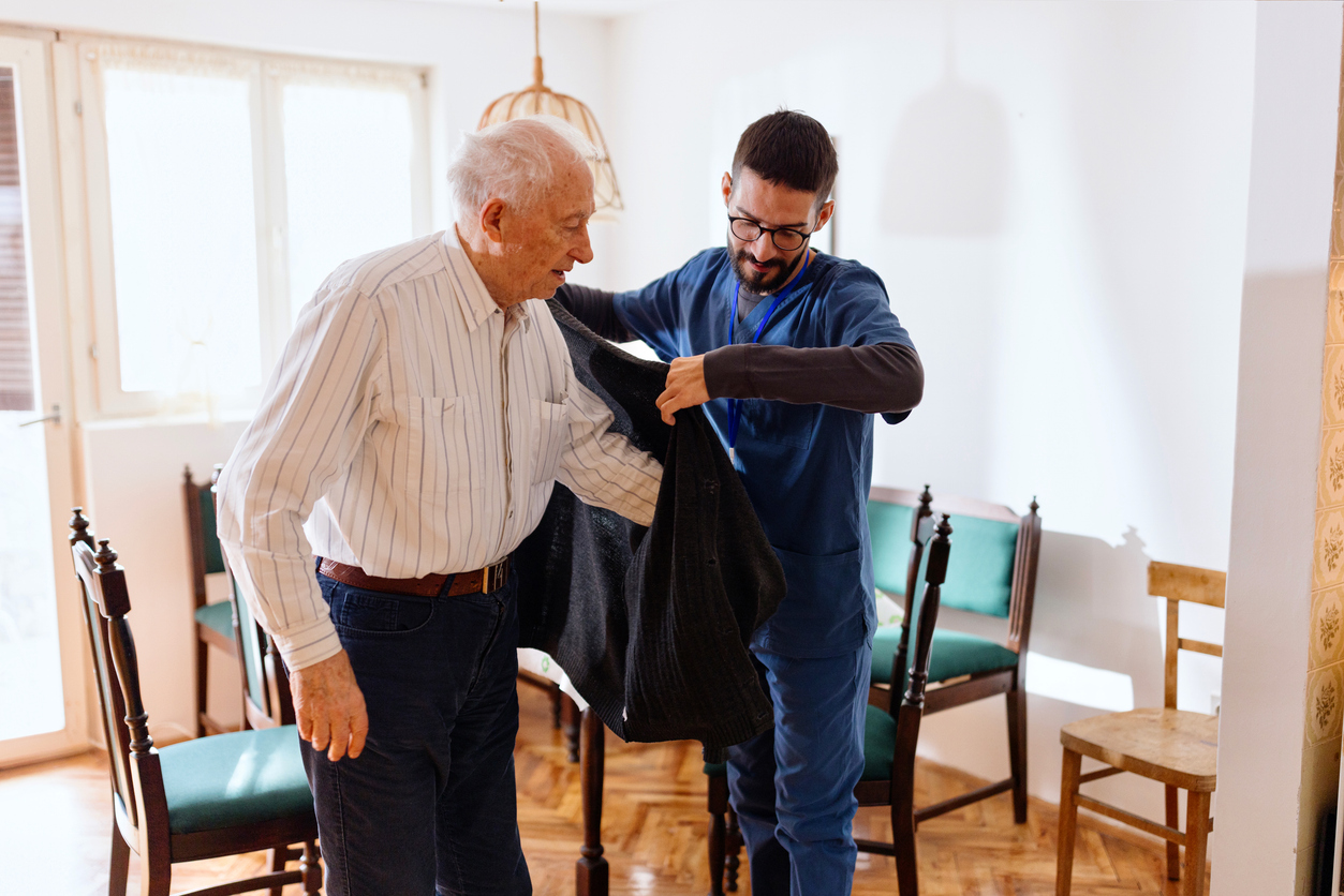 Nurse Helping Senior Man at Home