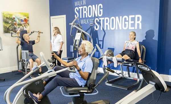 seniors work out in well-equipped gym with specialist on staff