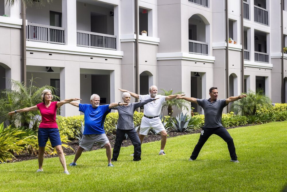 Seniors participating in yoga class outside