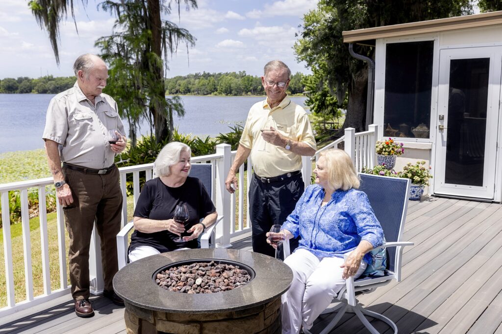 Seniors couples having a glass of wine on back porch