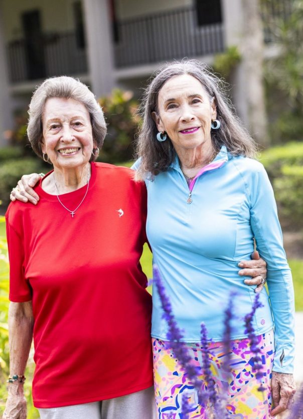 senior friends smiling, standing side by side