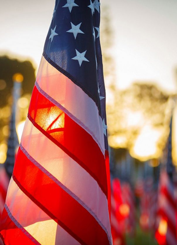 American flag in front of a sunset