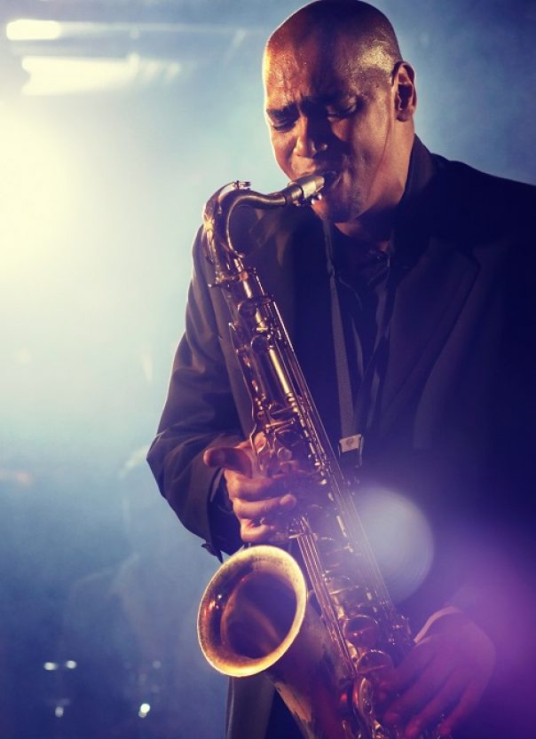 professional jazz player on stage with saxophone