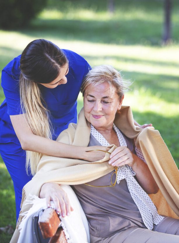 Nurse helping old woman for comfort and care
