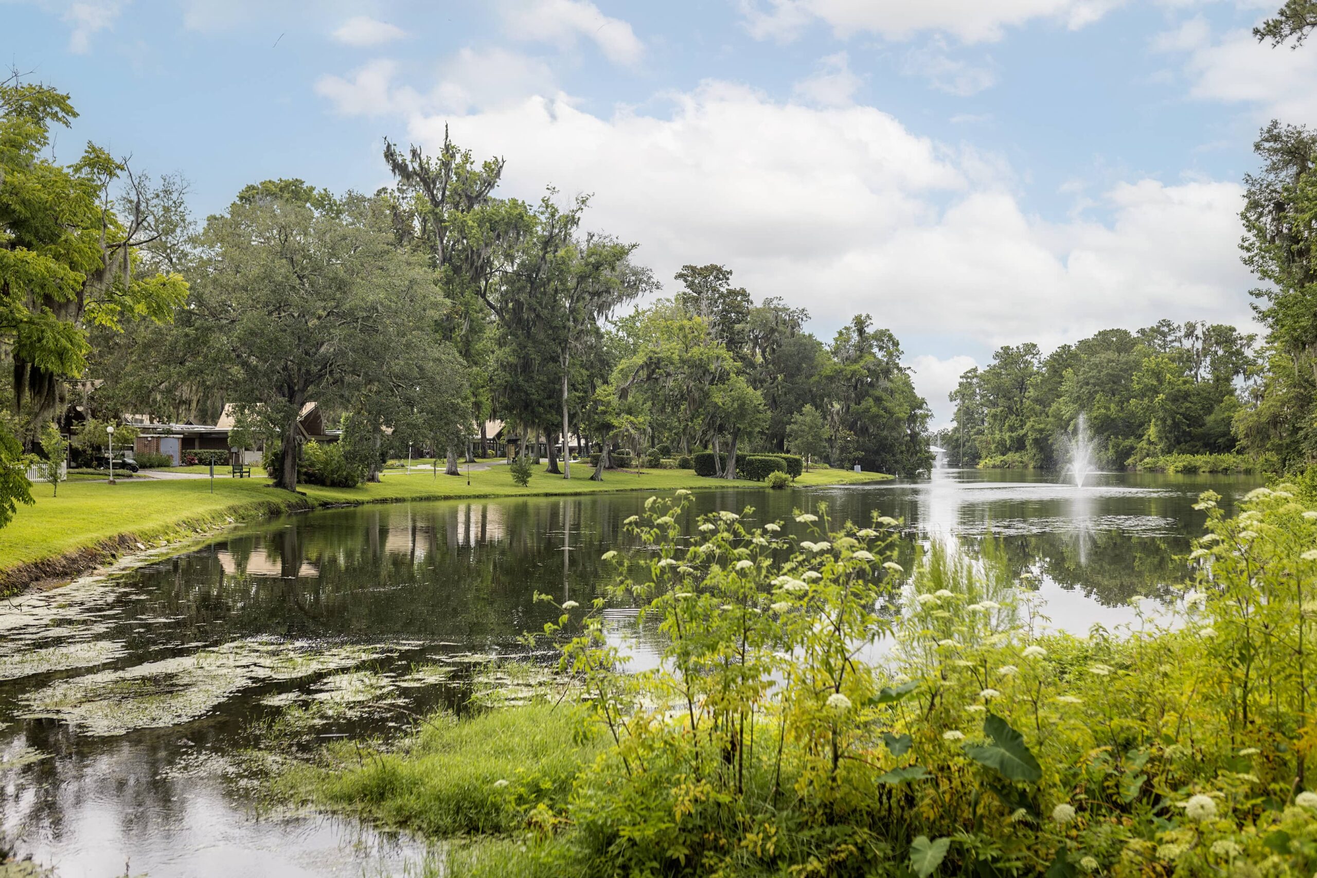 Lake at Westminster Woods at Julington Creek with fountains surrounded by trees