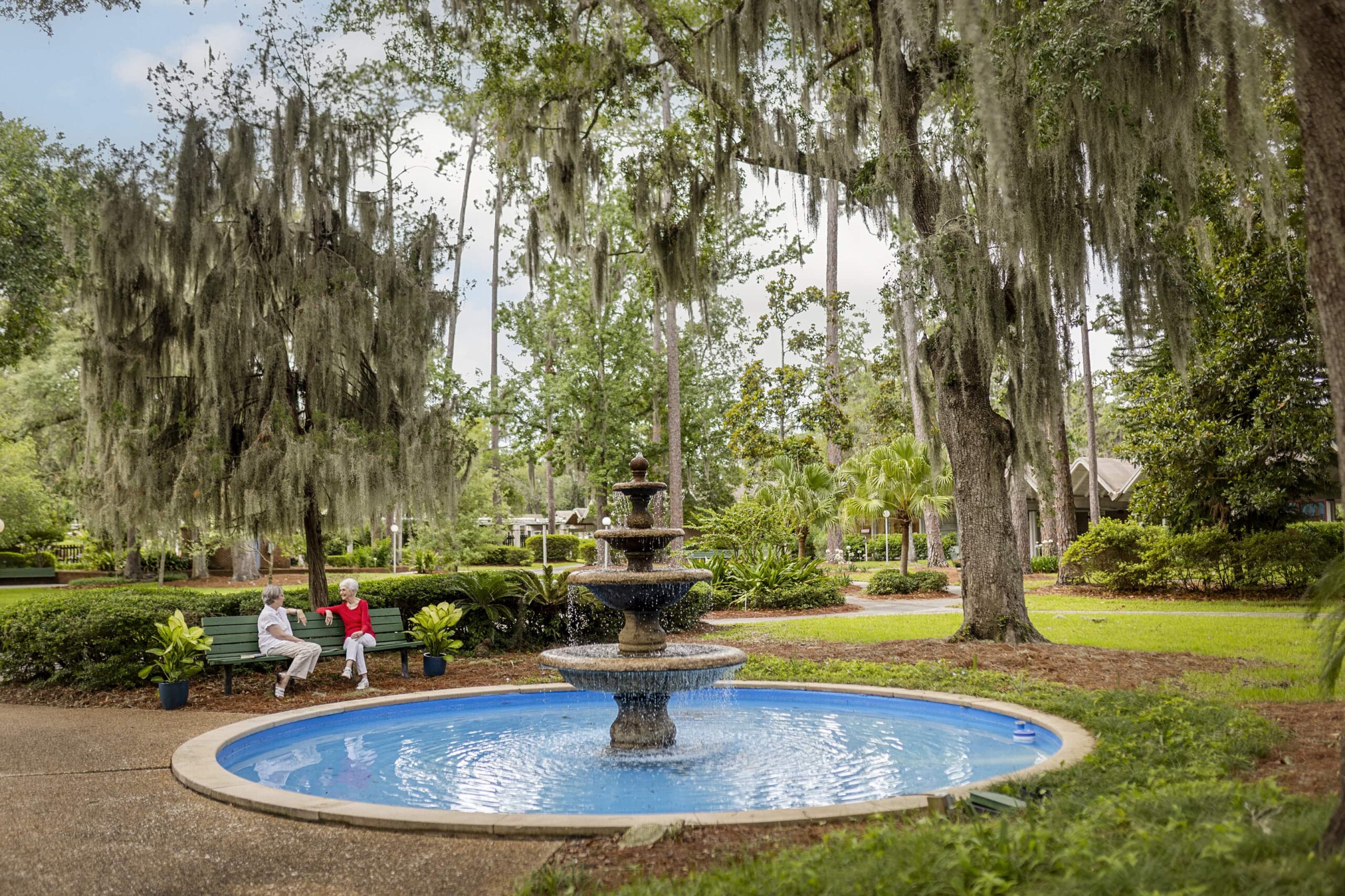 ladies sitting on bench near fountain at Westminster Woods at Julington Creek