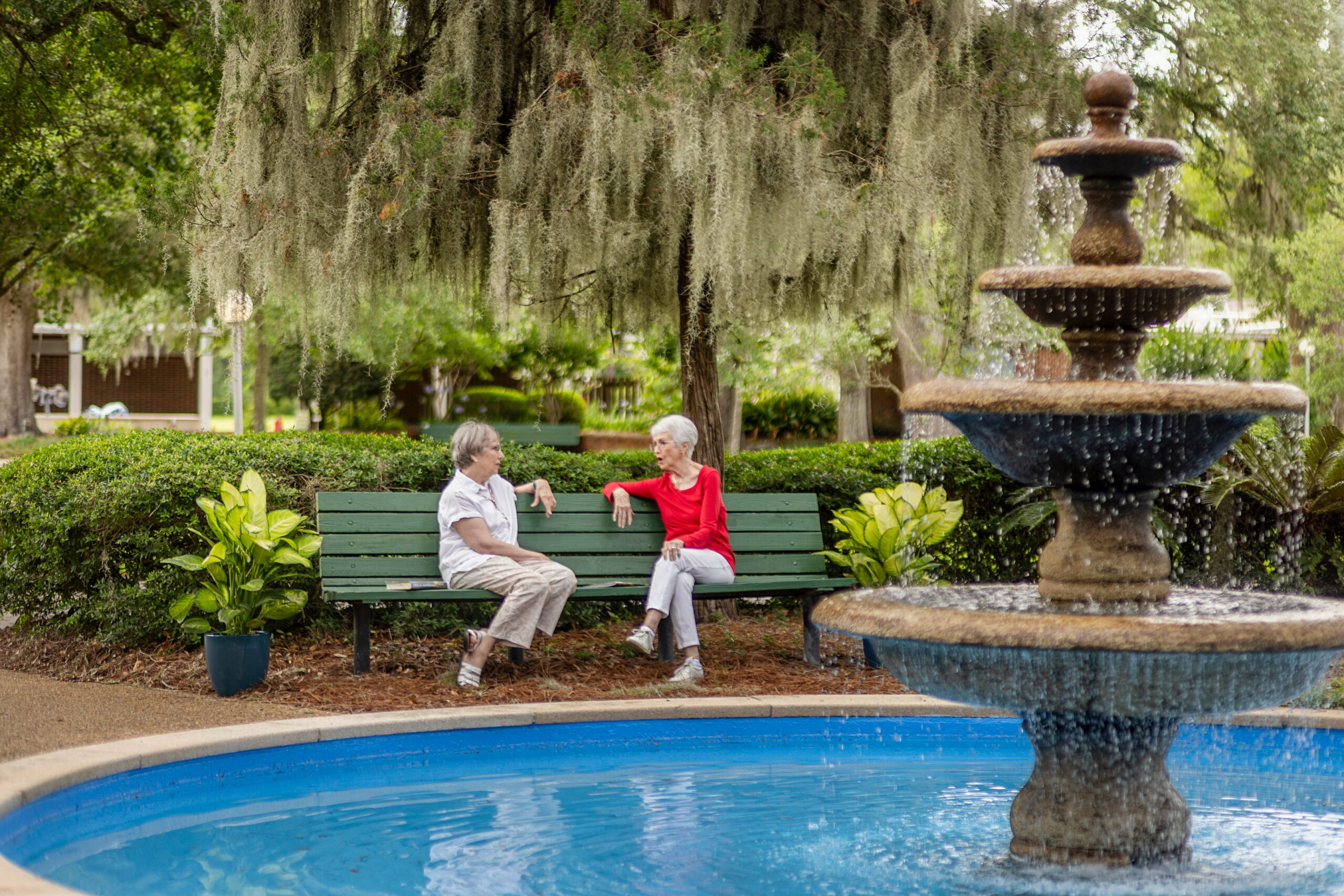seniors lounging by fountain