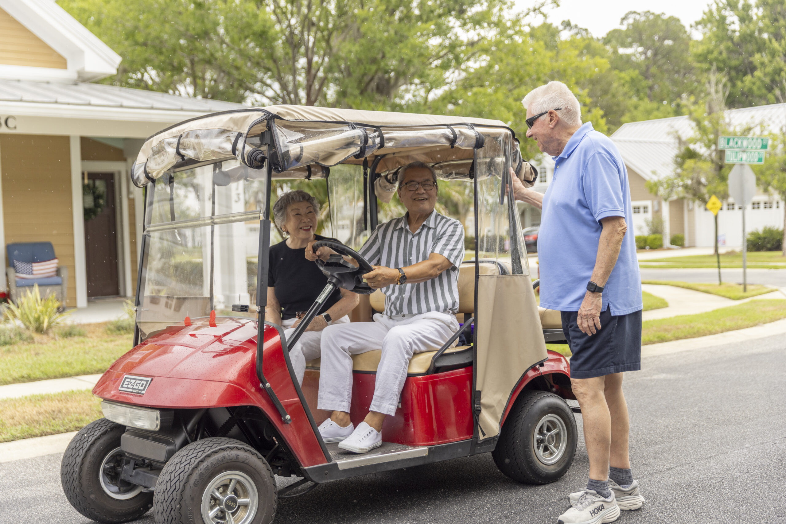 seniors riding golf cart