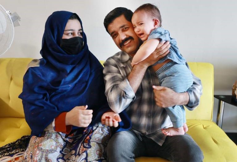 M.Z. with his wife and child, photo courtesy of Orlando Sentinel