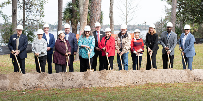 Westminster Communities of Florida leadership, Westminster Woods on Julington Creek leadership and members of the community's resident council turn the shovels on The Woodlands at the groundbreaking ceremony.
