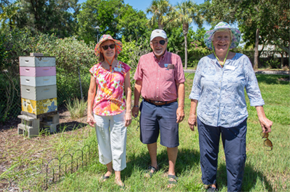 Seniors Smiling Near Apiary