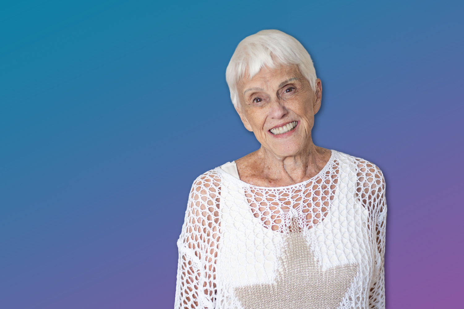 Westminster Towers resident Jean Peelan, a senior woman, smiles in a white top