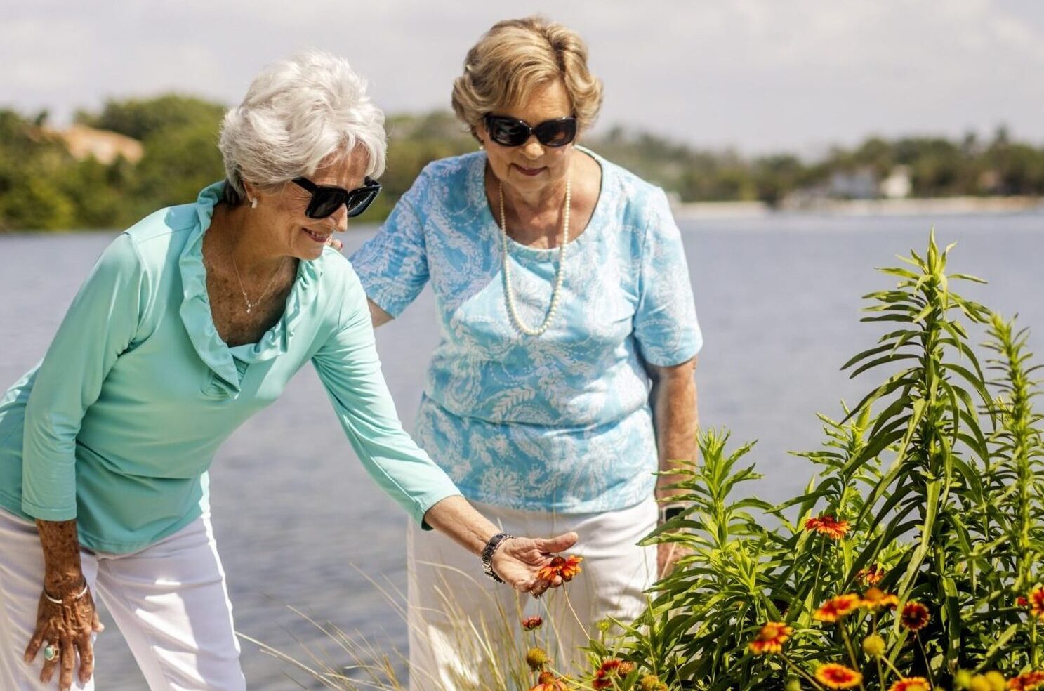 Two Senior Women Looking at Beautiful Flowers