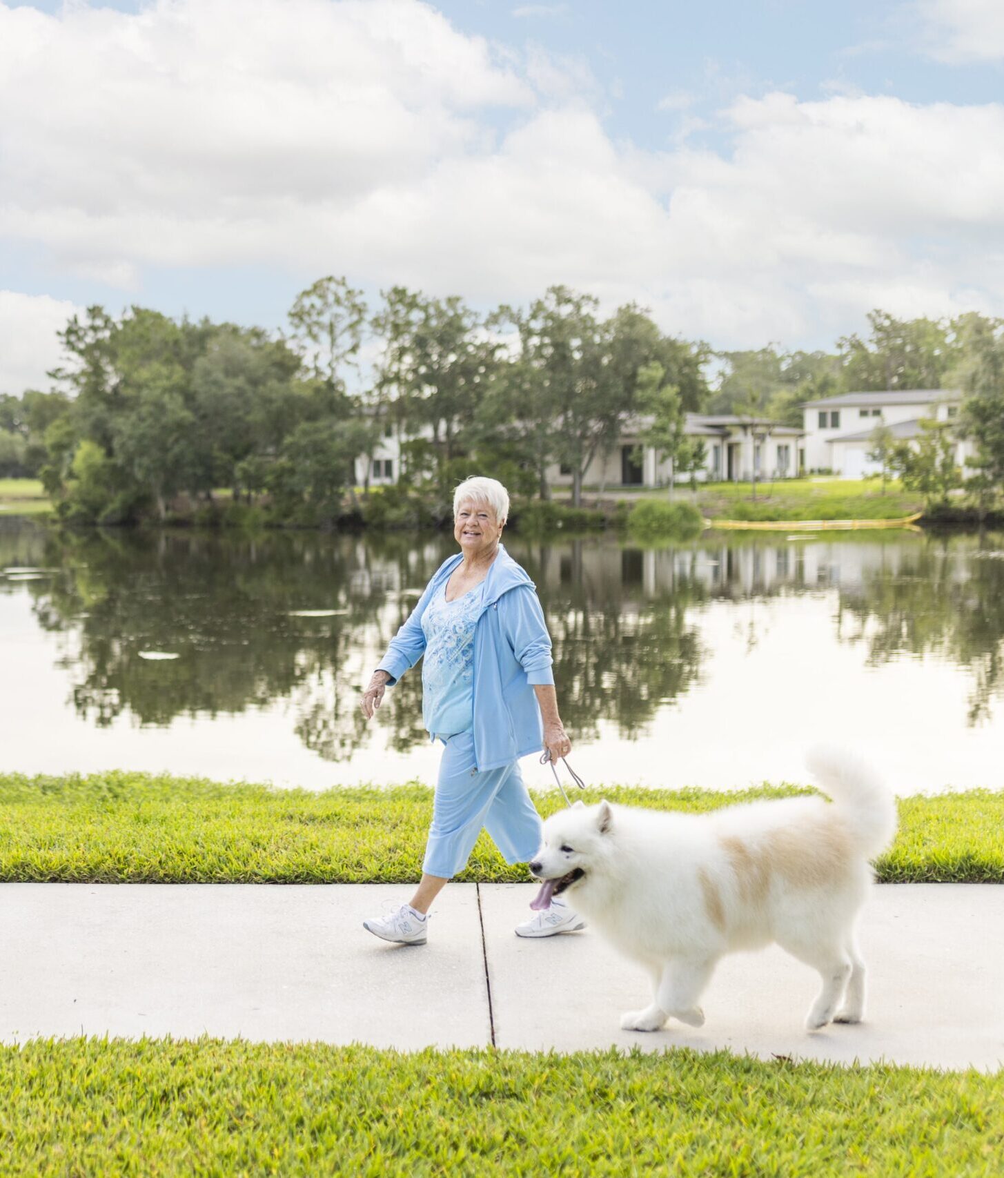 Senior woman walking dog