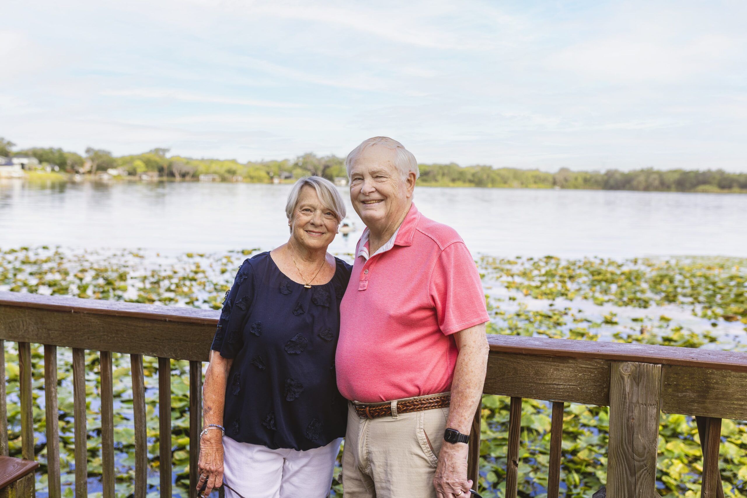 Senior couple taking photo by water
