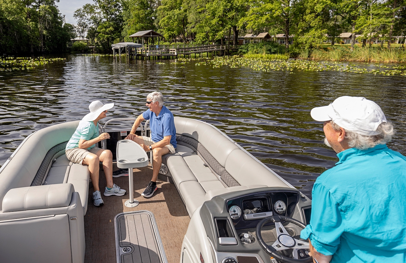 A couple conversing in a boat at Westminster Woods on Julington Creek