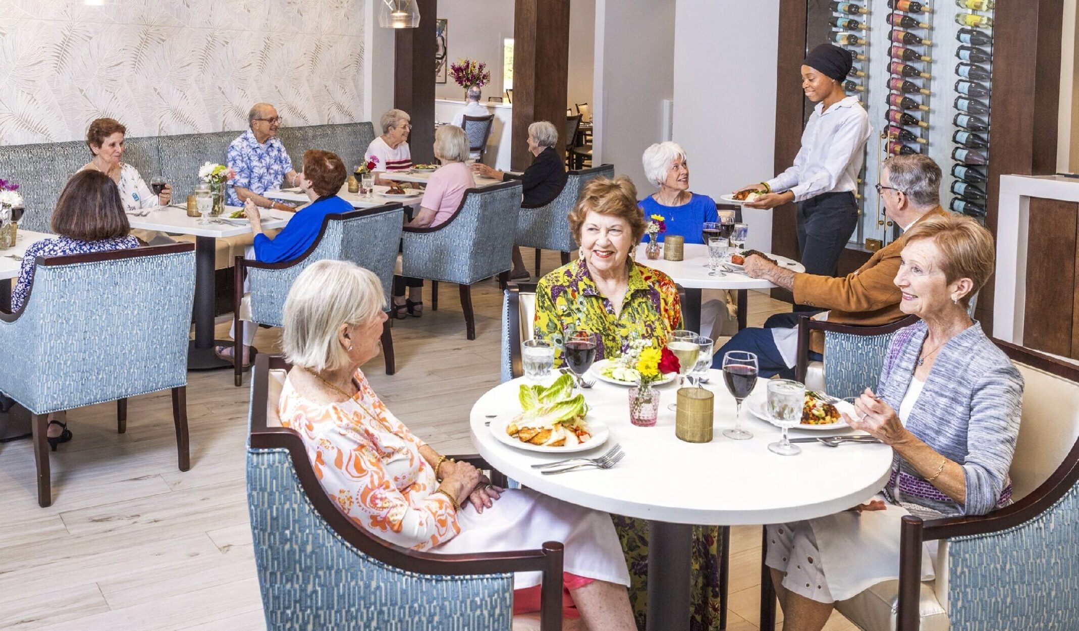 A group of senior women enjoy dinner together