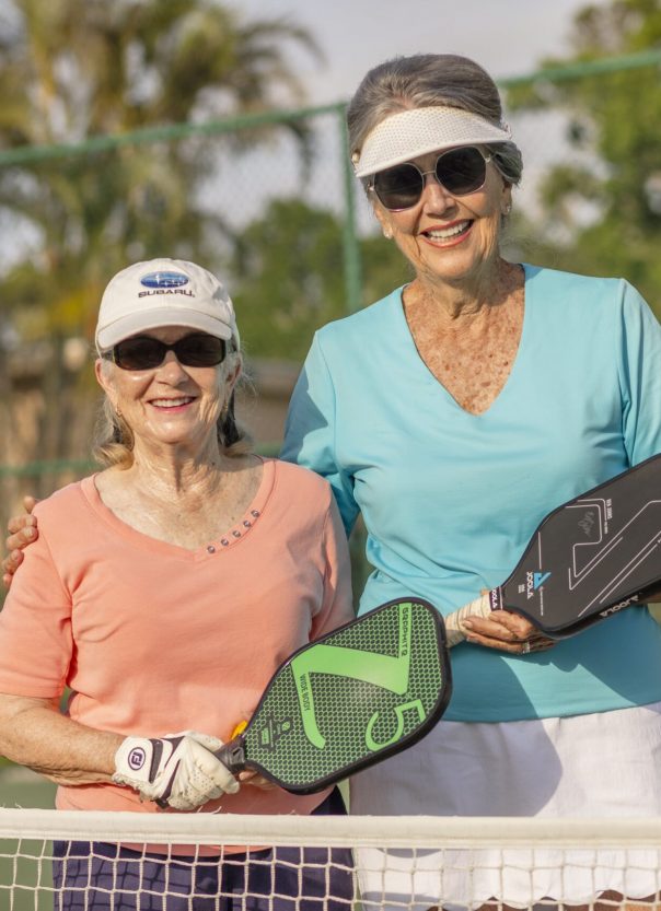Senior Woman Pickleball Senior woman smiling with their pickleball paddles