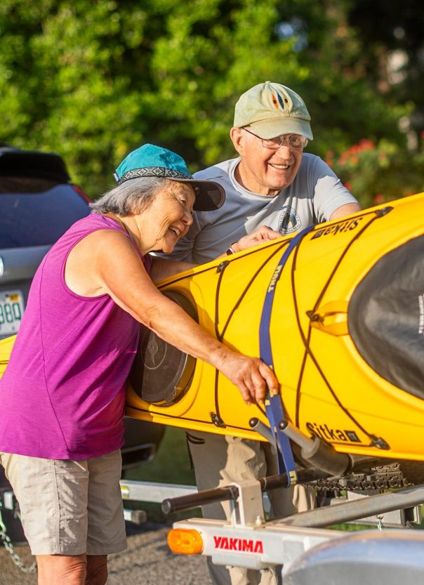 Senior couple getting ready to go kayaking