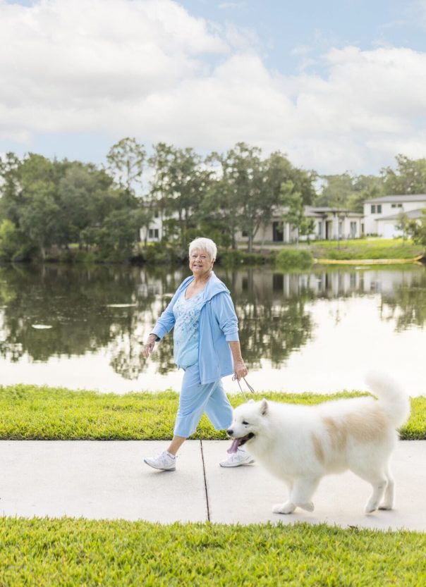 Senior woman walking dog