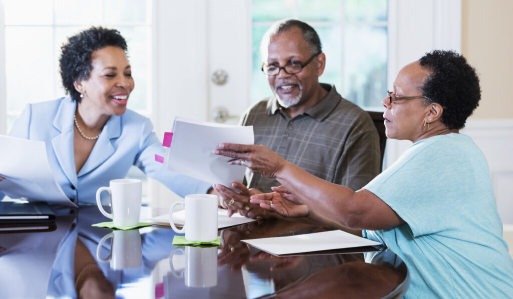 Senior couple researching assisted living in Florida with a financial advisor
