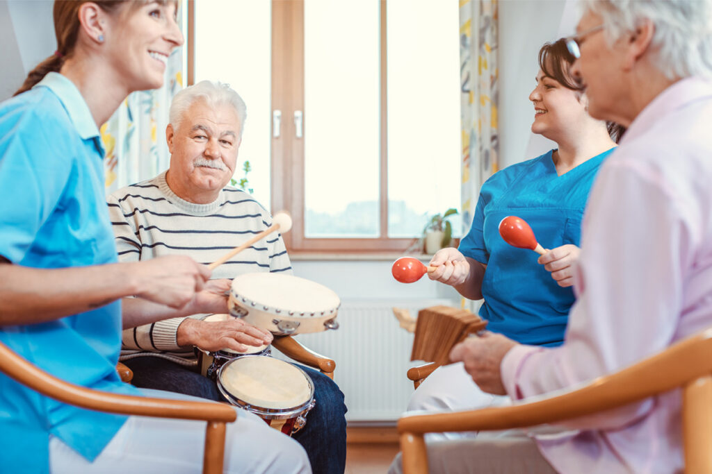 Seniors making music with rhythm instruments in memory care group