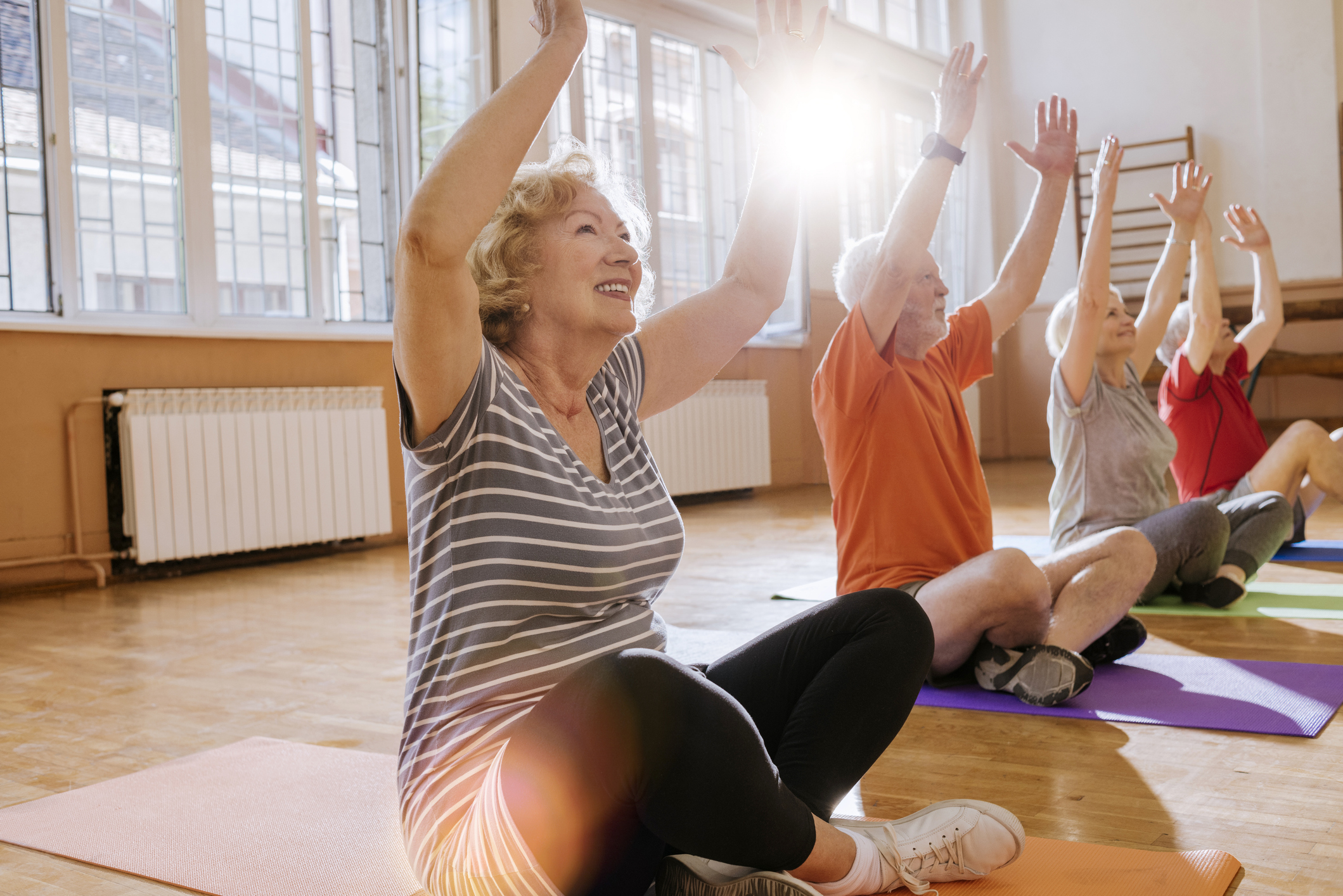Active seniors enjoying yoga stretches