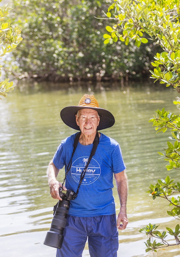 Man standing with a professional camera at Westminster Shores