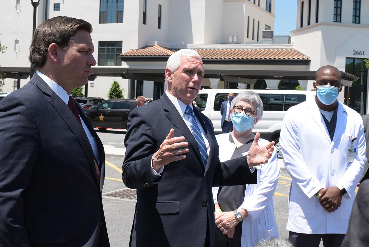 From left, DeSantis and Pence speak with Schultz and Romelus about the challenges of providing a safe environment for residents and team members.