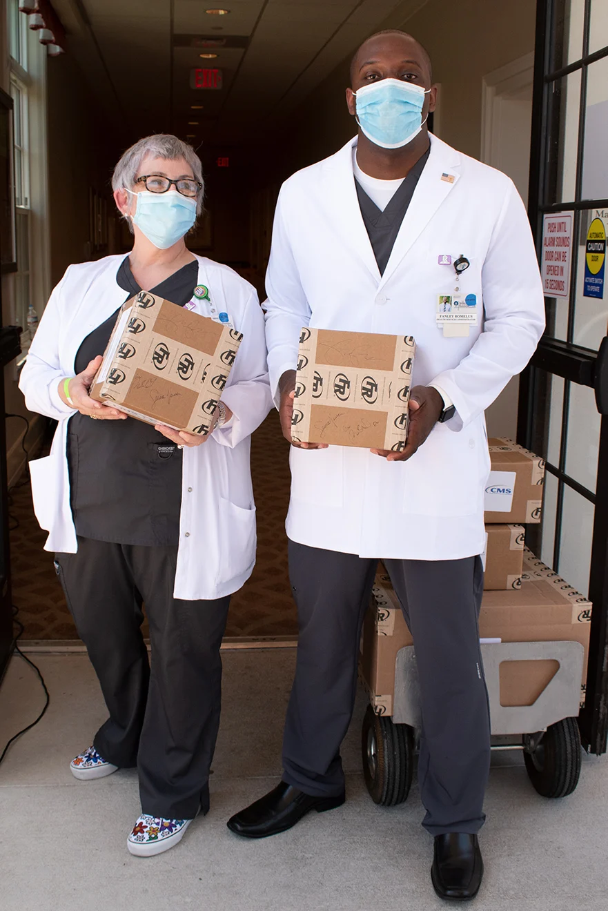 From left, Shirley Schultz, Director of Nursing, and Fanley Romelus, Health Services Administrator, hold boxes of personal protective equipment signed by Vice President Pence, Governor DeSantis and Administrator Verma.